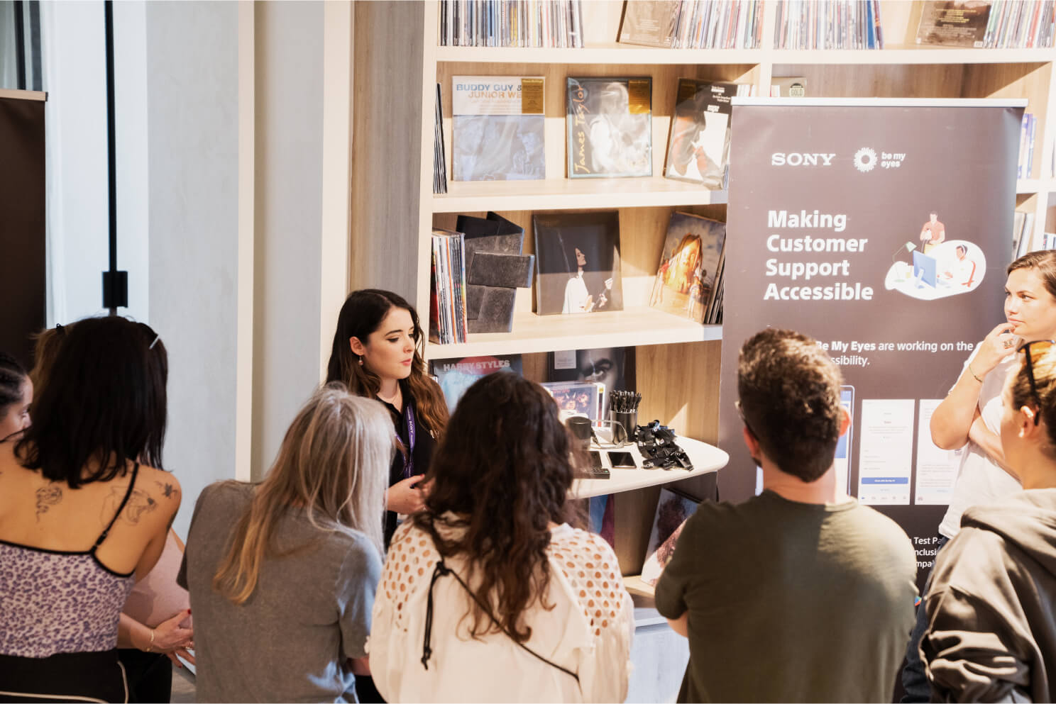Group photo showing three Sony employees chatting over coffee